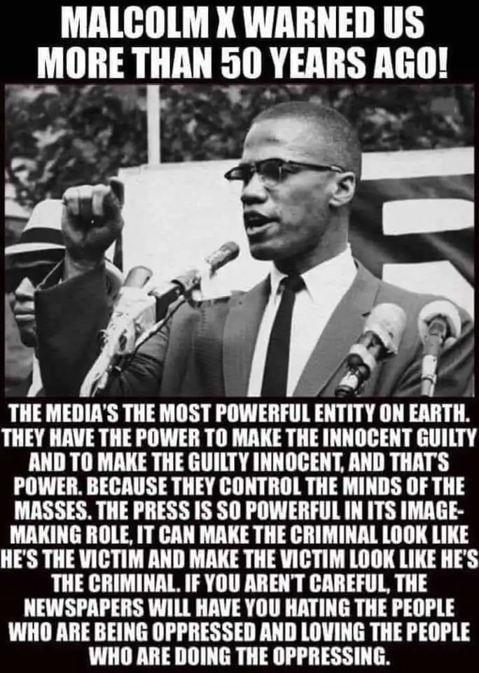 A black-and-white photo of Malcolm X speaking at a podium with multiple microphones, his right fist raised. Overlaid text at…